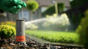 Adjusting Lawn Sprinkler Closeup Video. Garden Technician Work. video