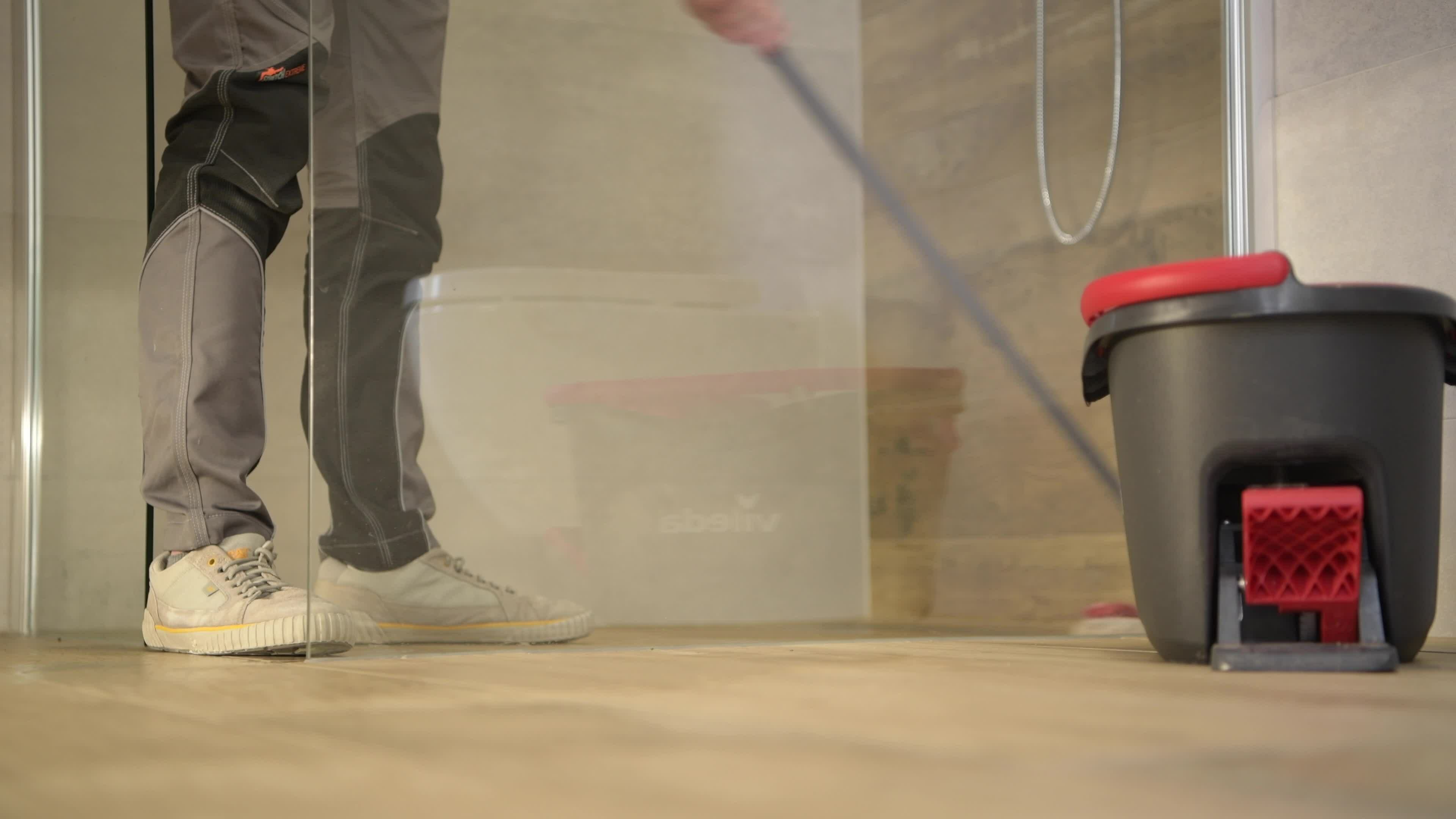 Caucasian Men Mopping Bathroom Ceramic Tile Floor. 25361125 Stock Video