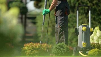 verano limpieza hora en el jardín. Lavado rutas utilizando presión lavadora video