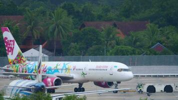 PHUKET, THAILAND NOVEMBER 25, 2016 - Sunday Airlines Boeing 767 taxiing tows a tractor from the service before departure at Phuket airport video