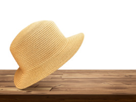 Straw hat laying on wooden table PNG transparent