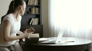 Young lady is dealing with some documents in her office at home video