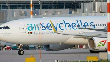 DUSSELDORF, GERMANY JULY 21, 2017 - Air Seychelles Airbus 330 S7 VDM taxiing to the start at sunset. Dusseldorf airport video