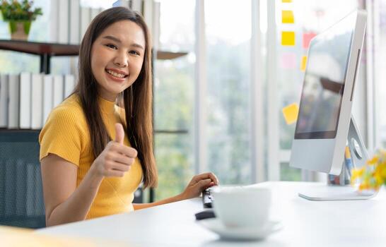 Portrait happy young programmer Asian woman work at start up technology office and using computer for coding application program and fully creative. Concept of smart entrepreneur woman working. photo