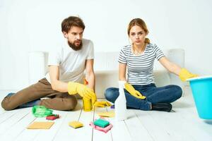 young couple washing floors working together on quarry detergent photo