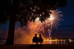 A young couple sit together to watch celebration fireworks in America. photo