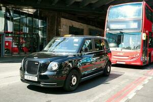 Beautiful Low Angle View of Central London and Road with Traffic and People. The Image Was Captured at Tower Bridge London England Great Britain on Warm Sunny Day of 04-June-2023 photo