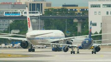 FRANKFURT AM MAIN, GERMANY JULY 17, 2017 - Air China Boeing 777 B 7952 towing from service and Aeroflot Airbus 320 VP BID taxiing after landing. Fraport, Frankfurt, Germany video