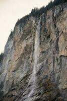 Staubbach Falls Kirche nature during winter in Lauterbrunnen, Switzerland. photo