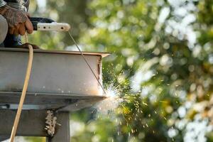 Metal welding steel works using electric arc welding machine to weld steel. photo