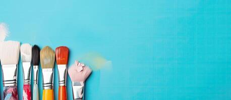 A group of paint brushes sitting on top of a blue surface created with technology photo