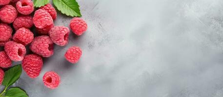 Raspberries with leaves on a gray background created with Generative AI technology photo