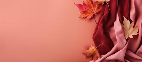 A pink background with autumn leaves on it created with Generative AI technology photo