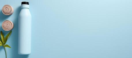 A blue bottle next to a plant on a blue background created with technology photo