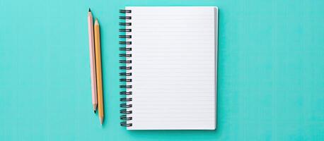 A notebook with a pencil on top of it created with technology photo