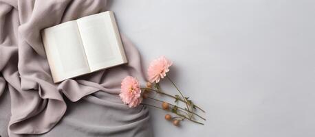 An open book and some flowers on a blanket created with technology photo