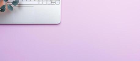 A laptop computer sitting on top of a pink table created with technology photo