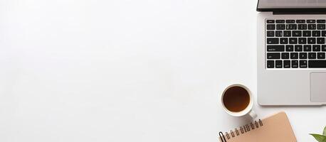 A laptop computer sitting on top of a desk next to a cup of coffee created with technology photo