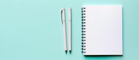 A notebook and pen on a blue background created with technology photo