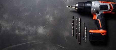 A drill and screwdriver on a black surface created with Generative AI technology photo