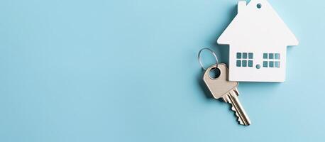 A house key hanging from a house shaped keychain created with technology photo