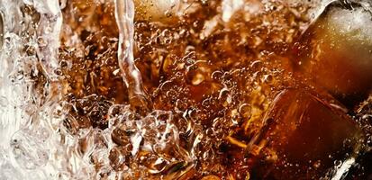 Splashing of Cola and Ice. Cola soda and ice splashing fizzing or floating up to top of surface. Close up of ice in cola water. Texture of carbonate drink with bubbles in glass. Cold drink background photo