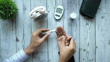 Top view of doctor measuring diabetic of senior woman video