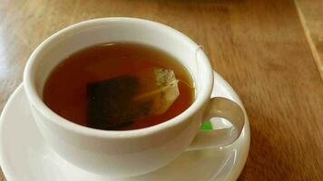 green tea and tea bag on table, close up video