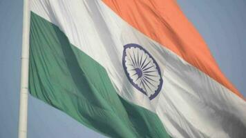 India flag flying high at Connaught Place with pride in blue sky, India flag fluttering, Indian Flag on Independence Day and Republic Day of India, tilt up shot, Waving Indian flag, Har Ghar Tiranga video