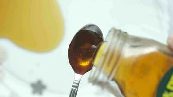 Close up of fresh honey pouring on a spoon video