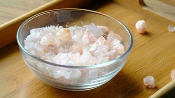 Close up of pink rock salt in a bowl on table video