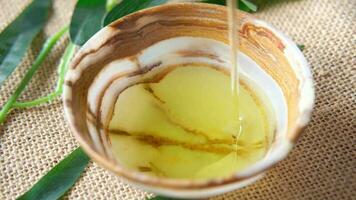 Pouring olive oil in a bowl close up video