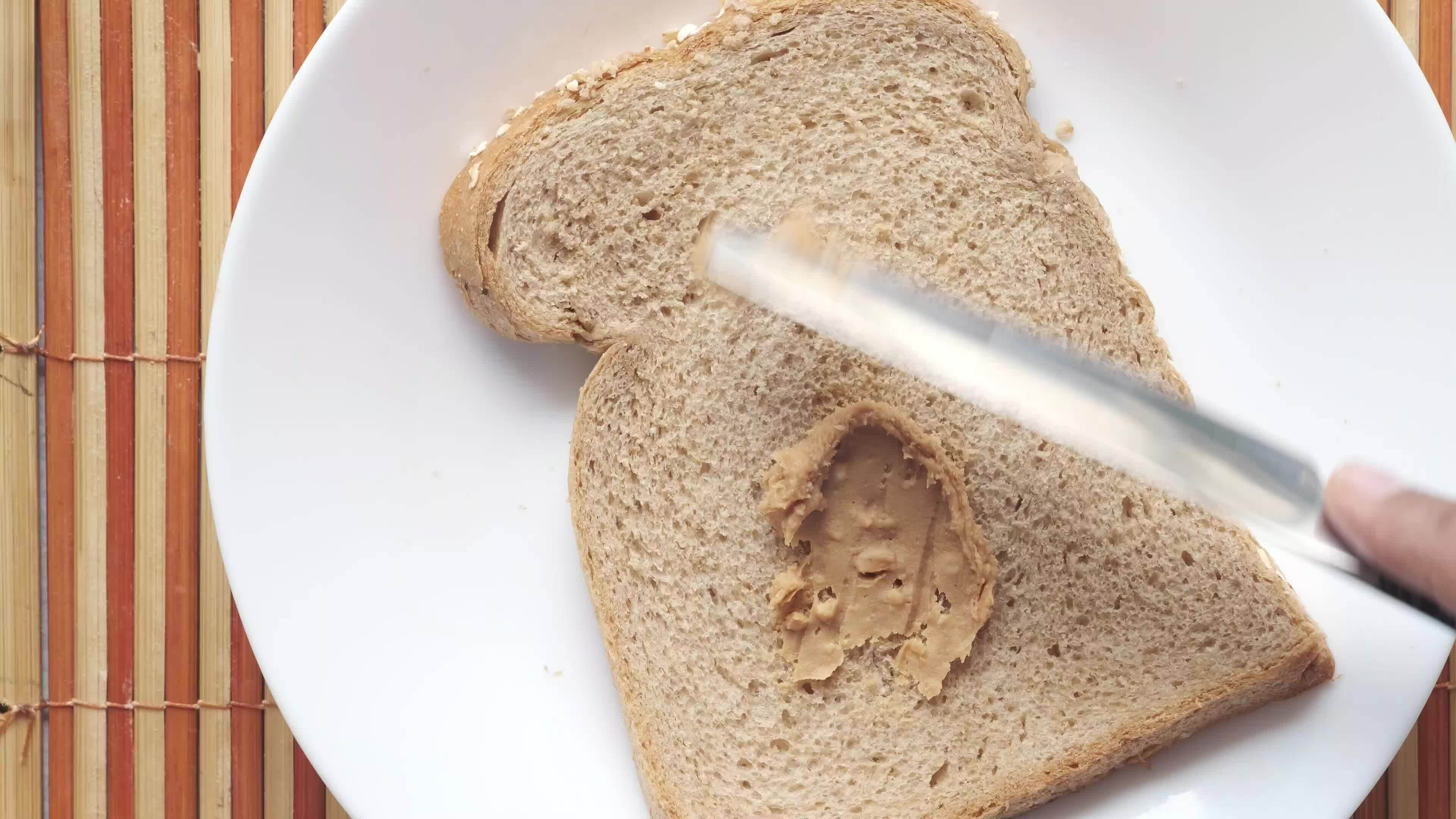 peanut butter spread on bread close up 25401614 Stock Video at Vecteezy