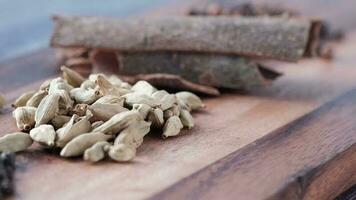 Spices and herbs on chopping board on table, top view video