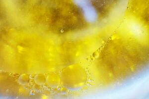 Gold Oil bubbles close up. circles of water macro. abstract shiny yellow background photo