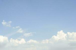 Sky landscape and few clouds in bright summer sunlight, with copy space. photo