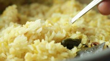 Cooked rice in a bowl on table, close up video