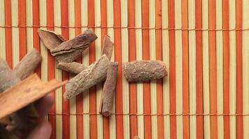 Spices and herbs on chopping board on table, top view video