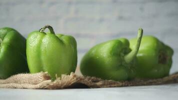 Yellow green and red capsicum on table, top view video