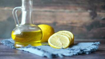 Glass container of oil and lemon on table video