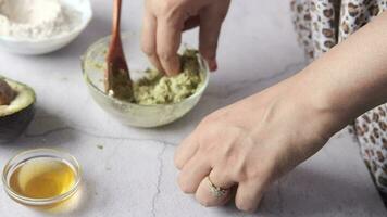 Woman applying homemade natural avocado cosmetic cream on skin video