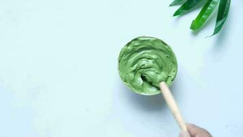 Bubble clay mask in container on white background video