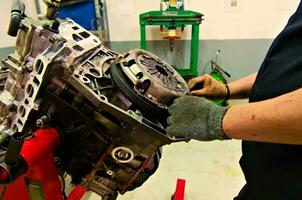 a car engine being assembled on an engine stand in a garage photo