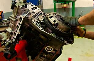 a car engine being assembled on an engine stand in a garage photo