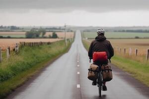 a man rides a bicycle on an empty road among a beautiful field, the concept of cycling travel generative ai photo