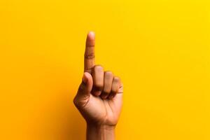 index finger on yellow background have an idea photo