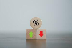 Closeup wood cubes with percentage symbol, Percent and upwards increasing arrows on wooden cubes. Financial interest mortgage rates increase or price commission raise, growth business, finance tax. photo