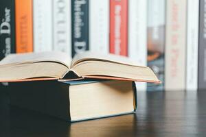 Book stack in the library room and blurred stack book for business and education background, back to school concept. Copy space for text. Distance education, e-learning concept. photo