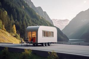 beautiful modern mobile home on an empty road against the backdrop of a beautiful mountain landscape photo