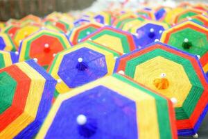 Rainbow umbrella on sky background. Many colorful umbrellas. umbrella street decoration photo